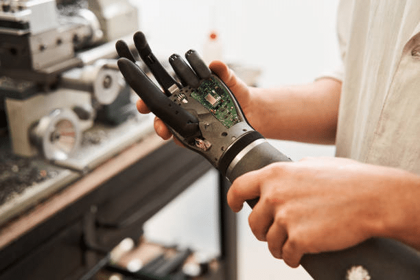 Technician holding a robotic hand